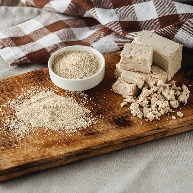 Frische Hefe & Trockenhefe auf einem Holzbrett